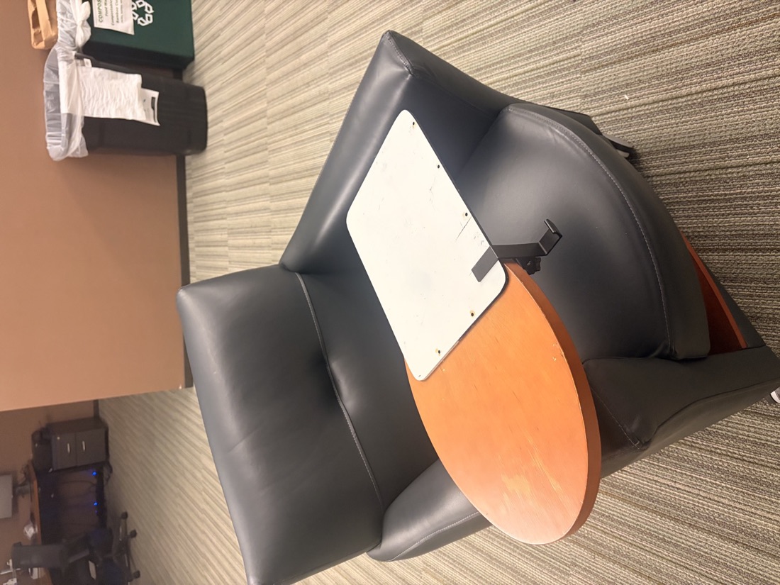 ClipDesk prototype board clamped to a lecture seat tablet arm, seen from above